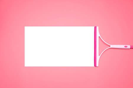 The pink glass wiper wipes the pink background in the middle of the picture with white spaces to be able to insert advertising materials, text, images.の写真素材