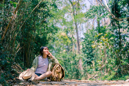 Woman traveler with backpack enjoying view at mountains in fog, freedom and active lifestyle concept.の写真素材