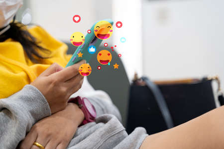 Social media and digital online concept, man using smart phone with Social media. The concept of living on vacation and playing social media. Social Distancing ,Working From Home concept.の写真素材