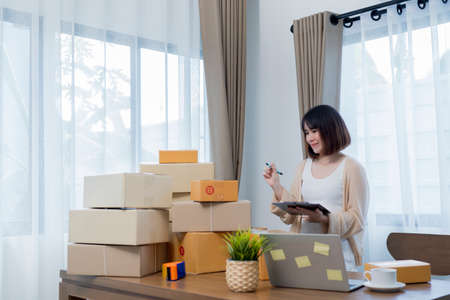 Startup small businessnworking with computer at workplace. Freelance woman seller check product order.market place.Online selling.Online Shopping. SME,E-commerce.の写真素材