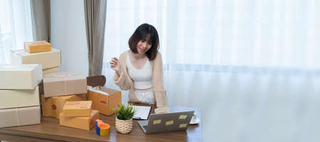 Startup small businessnworking with computer at workplace. Freelance woman seller check product order.market place. Online selling.Online Shopping. SME,E-commerce.の写真素材