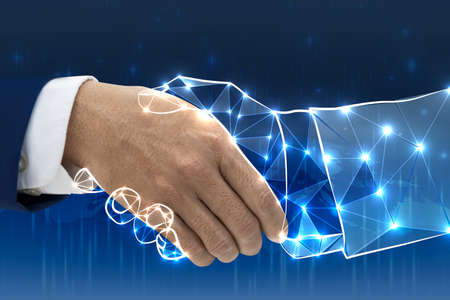 Abstract handshake on blue background. Teamwork and technology conceptの写真素材
