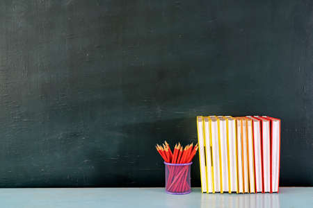 Back to school. Optional red pencils, books and blackboards have space to insert text.の写真素材