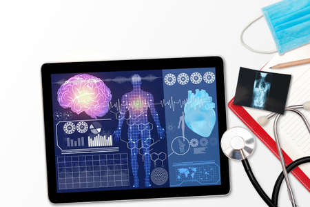 Black tablet pc and stethoscope medical instruments notebook and x-ray film on gray surfaceの写真素材