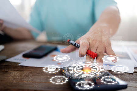 Money Saving Ideas Create savings or investment ideas for the future. Businessman holding piggy bank documents on table with calculator icons related to investment finance.の写真素材