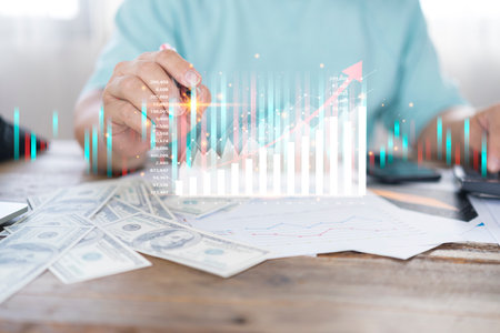 Businessman hand drawing virtual increasing graph with money coins stacking , Business investment profit and deposit dividend saving growth in 2021 concept.の写真素材