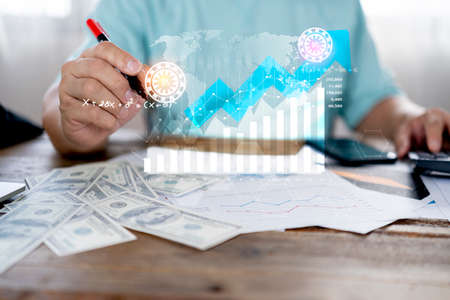 Business people planning dollar collection, progress or success concept. Businessman showing a growing virtual graph on the desk. invest in trading, investment successの写真素材