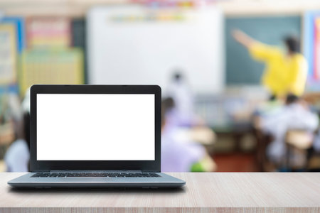 laptop computer on the table Children's classroom blur as backgroundの写真素材