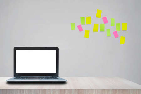 Modern creative workplace with laptop notebook mock up white empty screen on desk with moodboard sticky notes at work space home office roomの写真素材