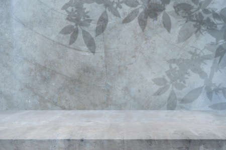 Marble Table with White Stucco Wall Texture Background with Light Beam and Shadow, Suitable for Product Presentation Backdrop, Display, and Mock up.の写真素材