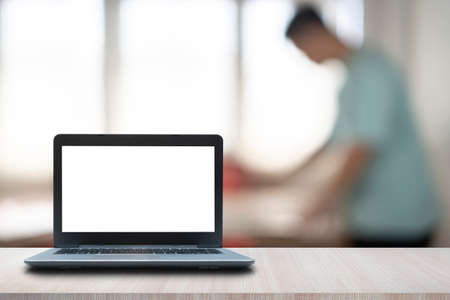 Empty space,Wood Desk with Laptop with blank screen,Interior home blurred background at light bokeh.の写真素材