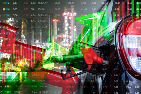 Parked car refueling pump, with computer screen with graph, Concept of energy business and stock market fluctuations.の写真素材