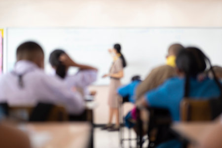 Blur abstract background teacher in front of classroom for meet the parent day. Blurry instructor teaching in school. Defocus open house day at campus for kindergarten students, student in classroomの写真素材