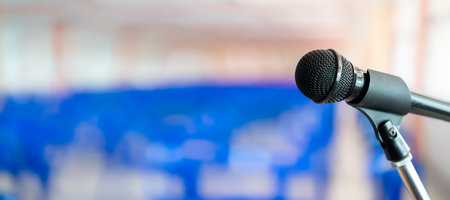 Microphone on abstract blurred of speech in seminar room or speaking conference hall light, Event Backgroundの写真素材