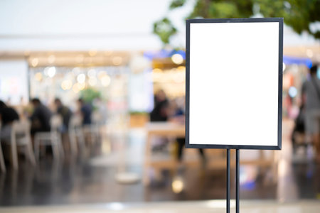 mockup white poster with black frame stand in front of blur restaurant cafe background for show or present promotion product conceptの写真素材