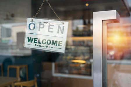 A business sign that says âOpenâ on cafe or restaurant hang on door at entrance. Vintage color tone style.の写真素材