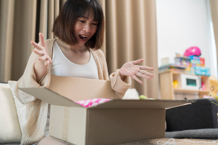 Woman sit on couch screaming with joy opens carton box feel happy, addressee girl received...