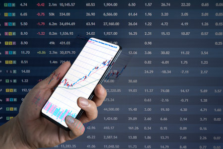 Businessman using smartphone, touching mobile phone investing application. Stock market investment...