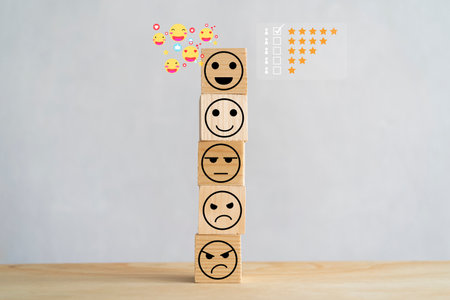 Wooden blocks with icon happy face smile symbol on wood table, evaluation, Increase rating, Customer experience, satisfaction and best excellent services conceptの写真素材