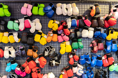 Boxing gloves hanging on wall. Many boxing gloves were hung on the wall in various colors. for use in boxing trainingの写真素材