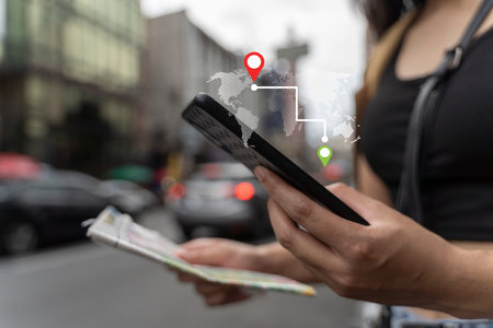 A woman uses a smartphone to check maps to travel with the internet and gps application for a vacation or holiday in Bangkok, Thailand.の写真素材