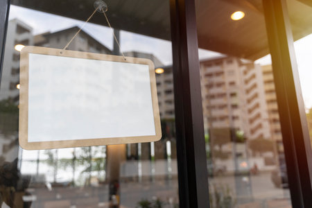 Coffee shop sign concept. Empty white retail store sign on blurry background. advertising concept. mock up, 3d renderingの写真素材