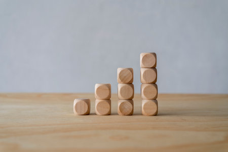 Wooden cubes arrange in pyramid shape on white background, business concept
