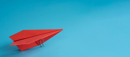 Red paper plane on blue background, top view. space for text, leadership concept. space can enter...
