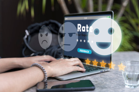 Online review rating women using laptop puts online rating. Five star rating. Rating star concept with woman using a laptop computerの写真素材