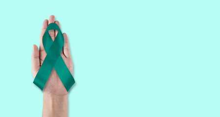 Teal awareness ribbon awareness for Ovarian Cancer month, cervical cancer, Polycystic Ovary Syndrome (PCOS) disease, Post Traumatic Stress Disorder (PTSD), Obsessive Compulsive Disorder (OCD)の写真素材