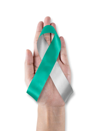 Teal and white ribbon for cervical cancer awareness month in Januaryの写真素材