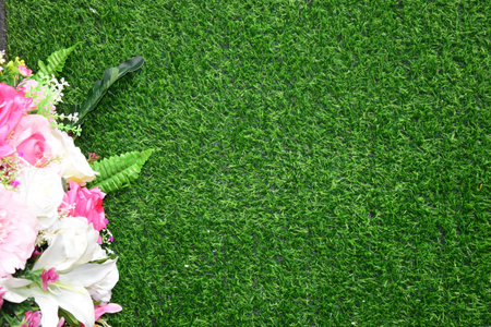 Combination of plants, artificial grass. Beautiful wall from various artificial creeper plant for background.staircase green artificial grass with pink flower.の写真素材