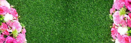 staircase green artificial grass with pink flower. Combination of plants, artificial grass. Beautiful wall from various artificial creeper plant for backgroundの写真素材
