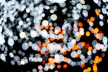 Holiday light bulbs. Cosmic background. red, gold and black glitter lights. defocused. Blurred background. Christmas background with lights.の写真素材