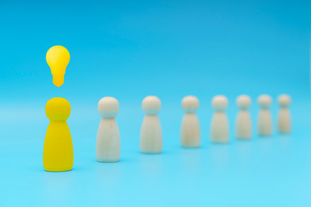 Outstanding yellow people standing with light bulb icon out from the crowd. Human resource, Talent management, Recruitment employee, Successful business team leader concept.の写真素材