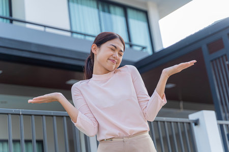 Portrait of asian girls standing and looking happy together in front of new house to start a new life. Family, age, home, real estate and people concept.の写真素材