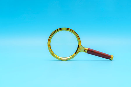magnifying glass on blue background. Small magnifying glass on blue background, search symbolの写真素材