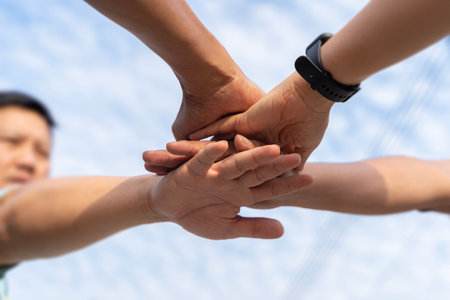 Close up low angle of business people putting their hands together. Stack of hands. Unity and...