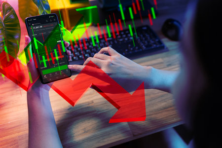 Hand holding smartphone for analyze. Online investment, percent and up or down arrow. Mortgage and loan rates. Interest rate, stocks, ranking. Business and finance concept.の写真素材