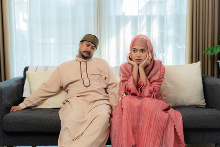 The quarrel of a guy and a girl. unhappy couple having argument at home. Relationship problems. Muslim couple arguing at home, her husband quarreling.の写真素材