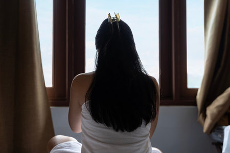 Hotel rooms are comfortable with a good sleep. Relaxing lifestyle of Asian girls in bed. Have a nice morning waking up relaxing and lazily relaxing in the city hotel bedroom.の写真素材