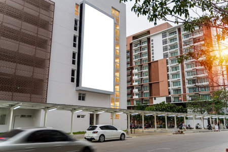 A large blank billboard on a street wall signboard with room to add your own message. Empty white poster on city building. Public ad and commercial concept. Mock upの写真素材