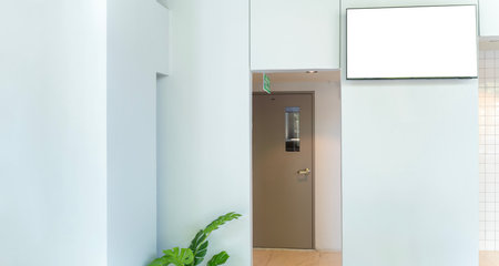LED TV white screen in elegant dining room at restaurant. Flat Smart TV Mockup with blank white screen for design, general information. Modern technology. Television advertising mediaの写真素材