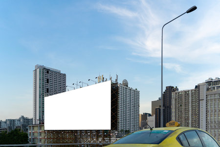 Large empty billboard ads along city highways on the background of a blue sky with beautiful clouds can be used for product display. Outdoor advertising posters for city streets, promotional posters.の写真素材