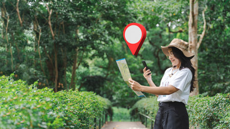 Tourists wearing white tops wearing brim hats using a navigation app on their mobile phones....