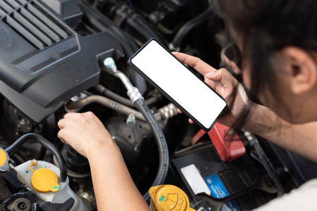 Closeup hands of of people called a helpline and waiting for repair service assistance with engine, broken car. Automobile emergency service to fix the problem or transportation and vehicle concept.の写真素材