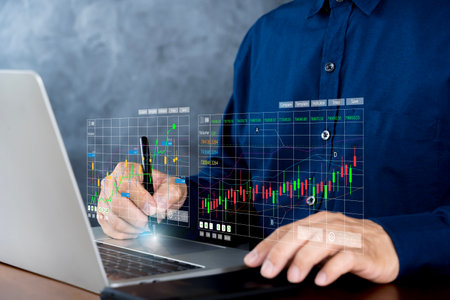 Trader use laptop analyzing growing stock on virtual screen for invest in trading. planning and strategy, Stock market, Business growth.の写真素材