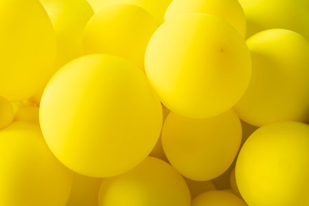 Group of yellow balloons create a background. a group of yellow balloons floating on a yellow...