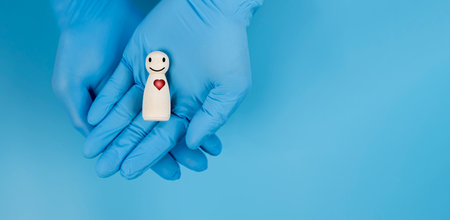 Doctor hand holding wooden block with smiling face and heartbeat icon  for checking the function of...