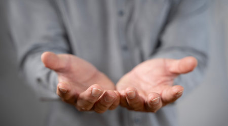 Hands, charity and palms of person for support, giving and hope for growth. Man, donation and hand gesture for kindness with help, community and gratitude or cupping for thank you, aid and povertyの写真素材